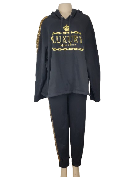 black tracksuit with gold accents and 'LUXURY' text on a white background