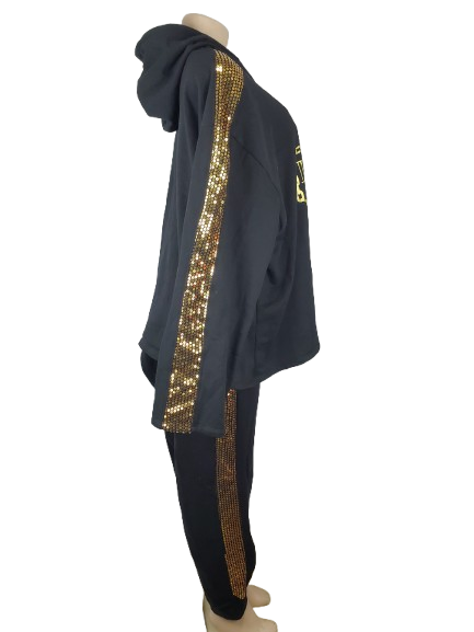 Black outfit with gold sequin stripes on a mannequin against a white background
