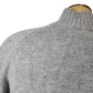 Gray sweater on a mannequin with a white background