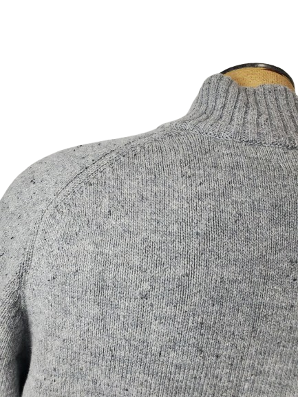 Gray sweater on a mannequin with a white background