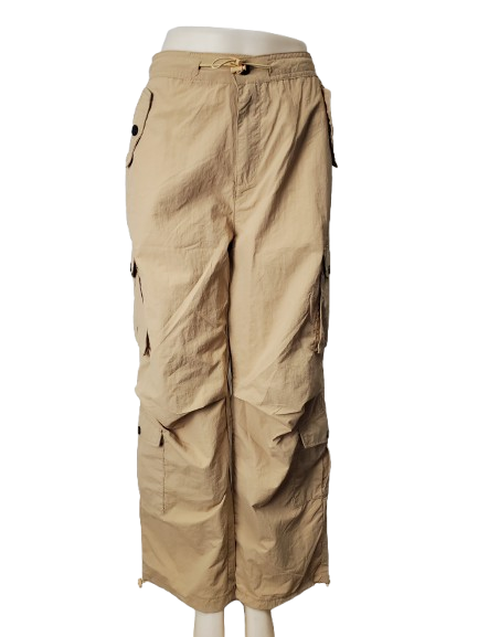 Beige cargo pants on a mannequin against a white background