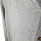 Close-up of a gray textured fabric with a button on a white background