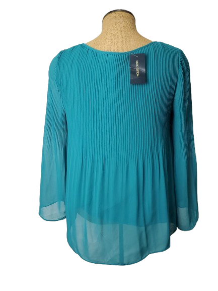 Teal blouse on a mannequin with a visible tag against a white background