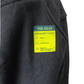 Black fleece jacket with a TEK GEAR label on a white background