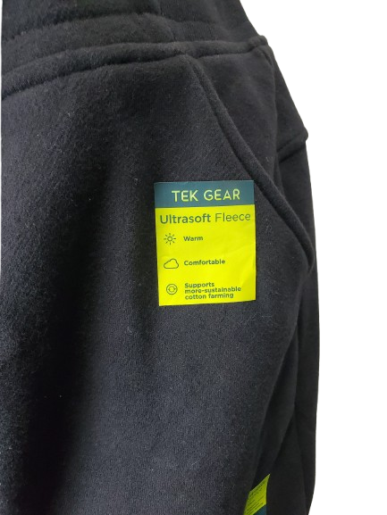 Black fleece jacket with a TEK GEAR label on a white background