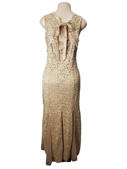 Beige lace dress with a bow on a mannequin against a white background