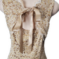 Lace dress with a ribbon on a mannequin against a white background