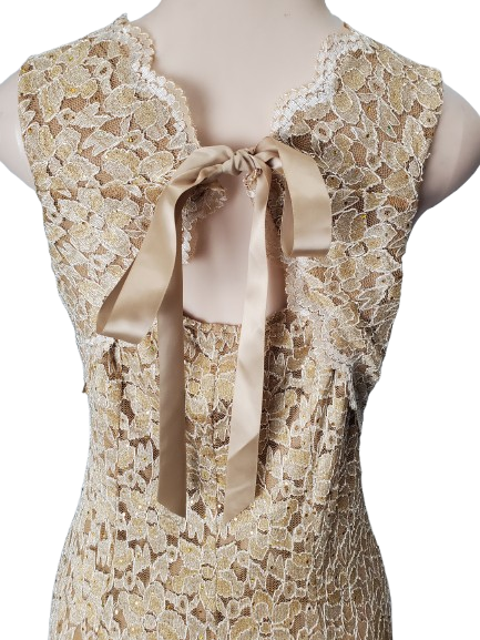 Lace dress with a ribbon on a mannequin against a white background