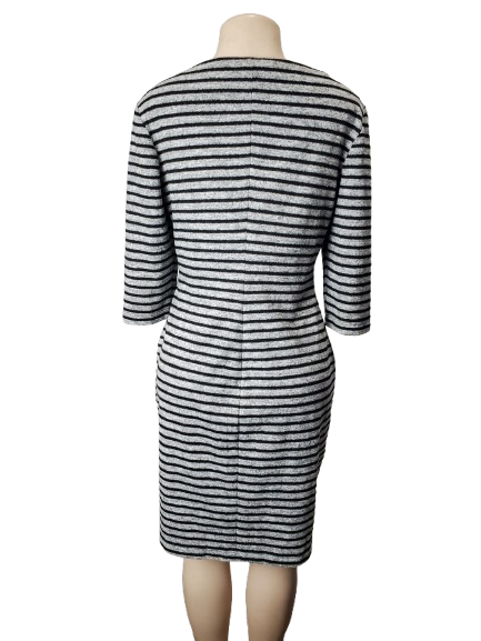 Mannequin wearing a black and gray striped dress on a white background
