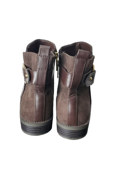 Pair of brown leather boots with zippers on a white background