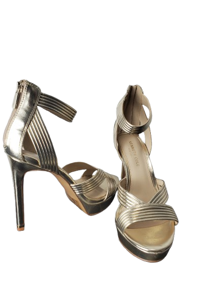 Pair of silver high-heeled sandals on a white background