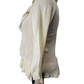 beige cardigan on a mannequin with a visible tag against a white background