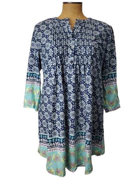 Blue and green patterned top on a mannequin against a white background