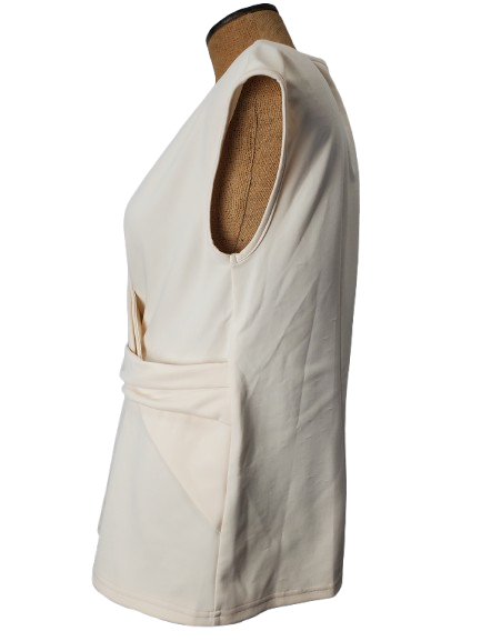 cream sleeveless top on a mannequin with a plain background