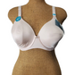 champagne  bra on a mannequin with visible tags against a white background
