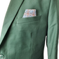Green suit jacket with a patterned pocket square on a white background