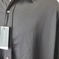 black polo shirt with a tag on a white background