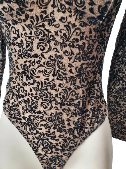 Black floral patterned fabric on a beige background