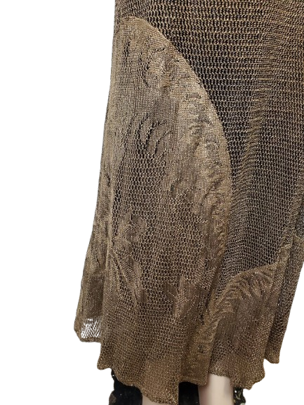 Close-up of a textured brown garment with intricate patterns on a white background