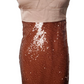 Beige top and brown sequined skirt on a mannequin against a white background