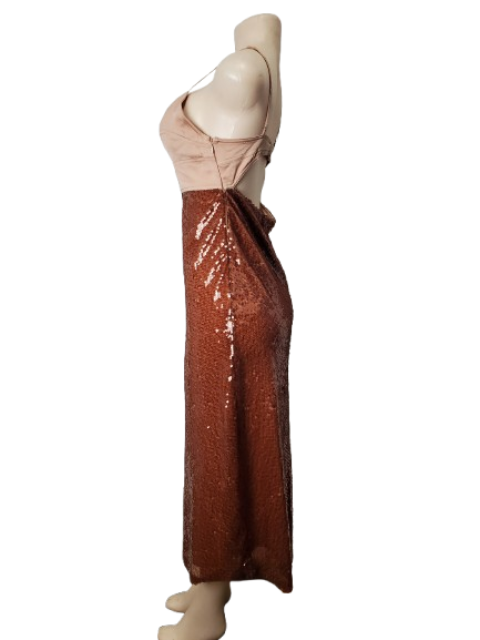 Mannequin wearing a beige top and brown sequin skirt on a white background