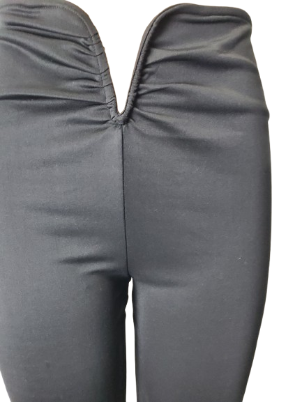 Close-up of black leggings with a plain background