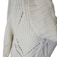 Close-up of a white knitted sweater with a geometric pattern on a white background