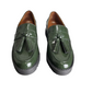 Pair of green loafers with tassels on a white background