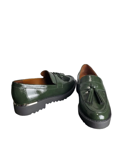 Pair of green loafers with tassels on a white background