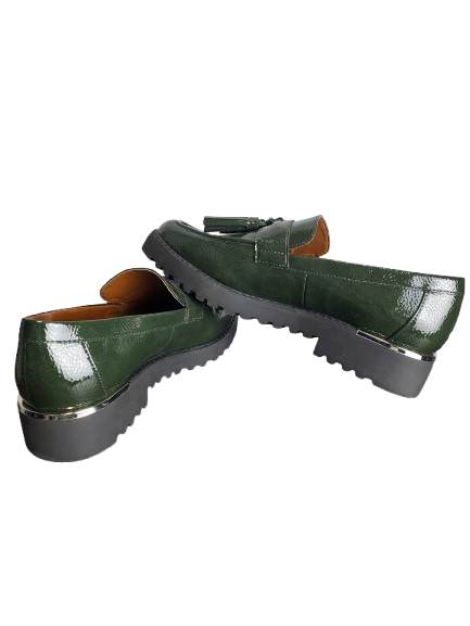 Green leather shoes with black soles on a white background