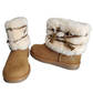 Pair of tan boots with white fur trim on a white background