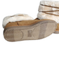 Pair of beige slippers with white fur lining on a white background