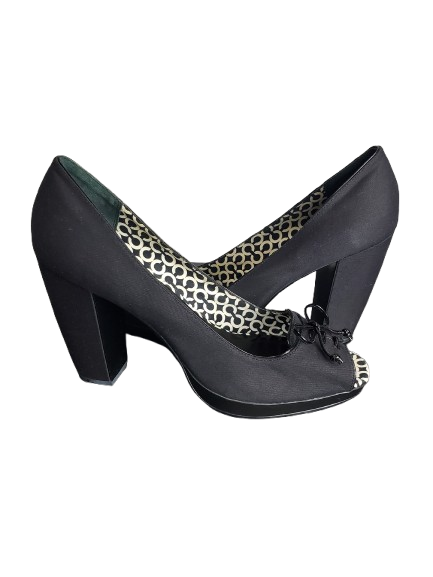 Black high-heeled shoe with a patterned inner sole on a white background