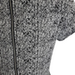 Close-up of a textured black and white garment with a zipper.