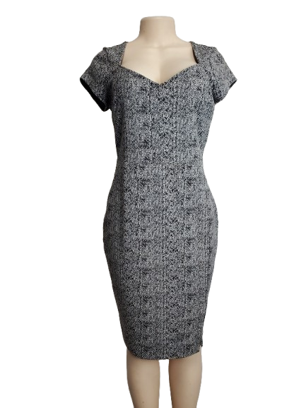 Black and white patterned dress on a mannequin against a white background