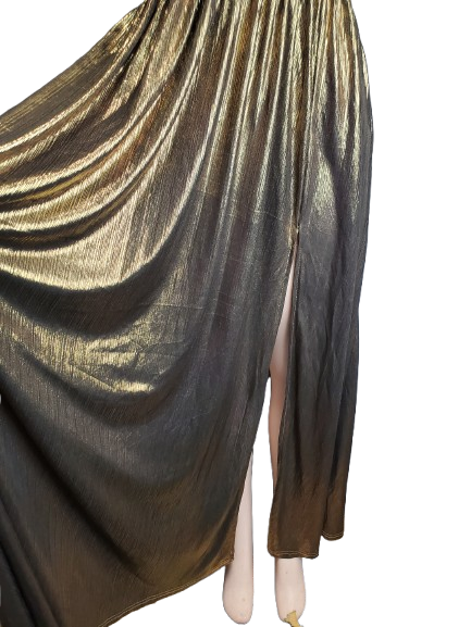 Gold and black draped fabric on a mannequin against a white background