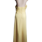 Yellow evening gown on a mannequin against a white background