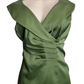 Green dress on a mannequin against a white background