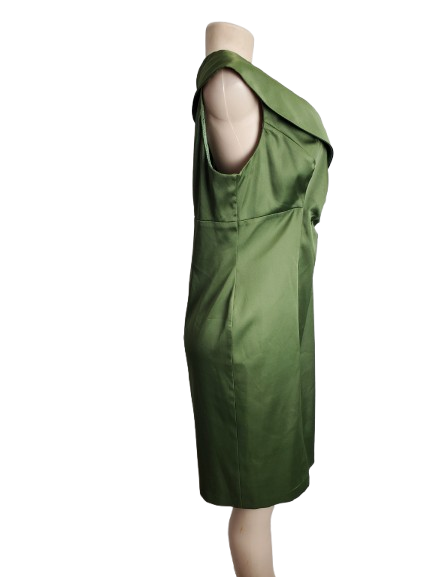 Green dress on a mannequin against a white background