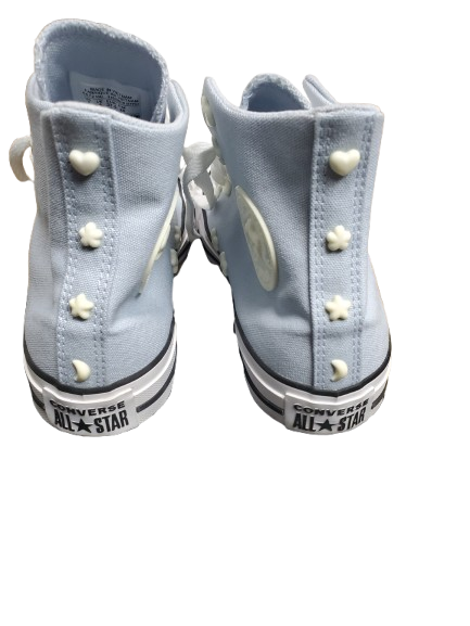 Pair of light blue high-top sneakers with white buttons on a white background