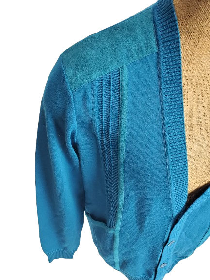 Blue cardigan on a mannequin with a white background