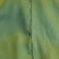 Close-up of green fabric with a visible seam