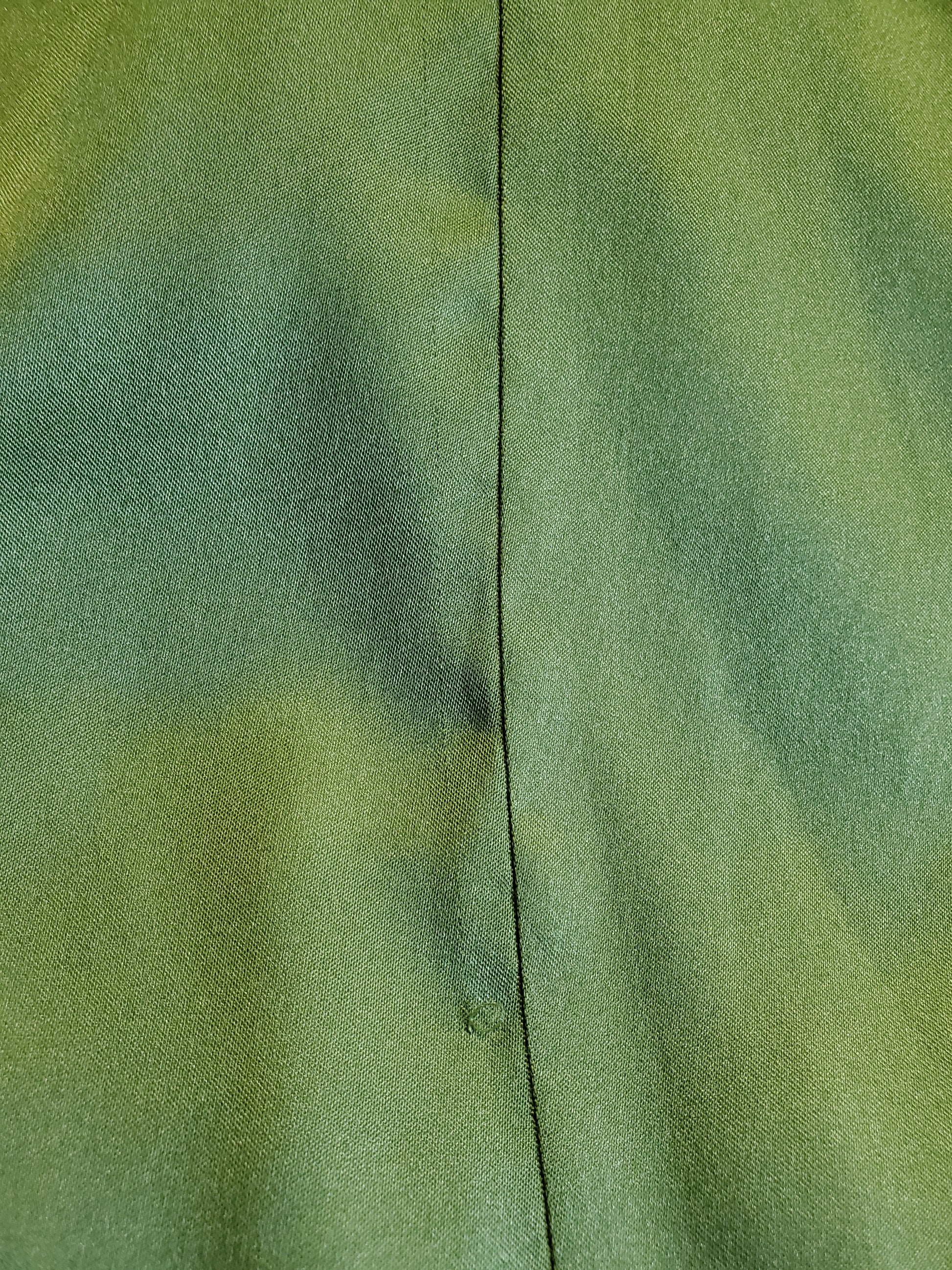 Close-up of green fabric with a visible seam