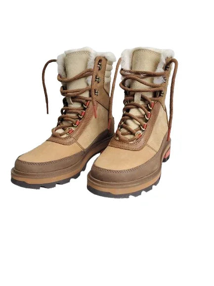 Pair of tan winter boots with fur lining on a white background