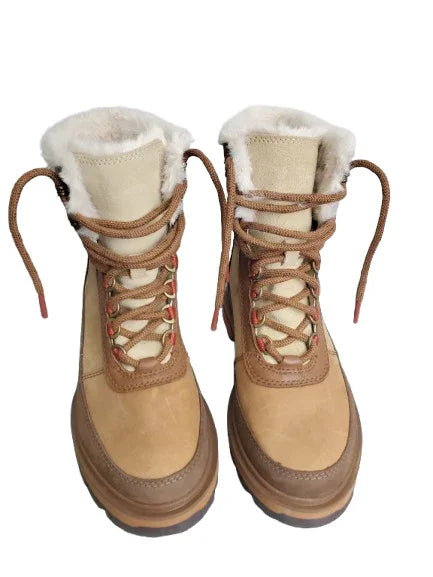 Pair of tan winter boots with white fur lining on a white background