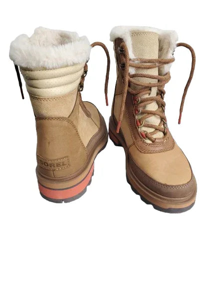 Pair of brown winter boots with white fur lining on a white background