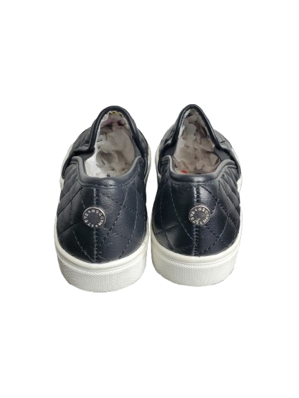 Pair of black slip-on sneakers with white soles on a white background