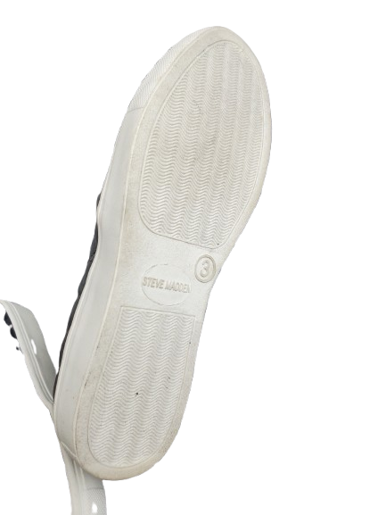 Close-up of a white sneaker sole with 'Steve Madden' branding on a white background