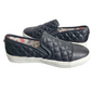 Pair of black quilted slip-on shoes on a white background