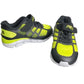 Pair of black and yellow running shoes on a white background